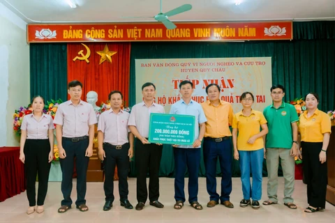 Công đoàn Ngân hàng Chính sách xã hội hỗ trợ 200 triệu đồng cho người dân tại huyện Quỳ Châu. (Ảnh: Vietnam+)