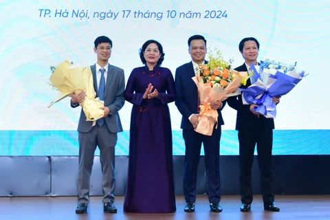 Thống đốc Nguyễn Thị Hồng tặng hoa chúc mừng tân thành viên Hội đồng quản trị kiêm Tổng Giám đốc VietinBank (thứ hai từ phải sang). (Ảnh: Vietnam+)