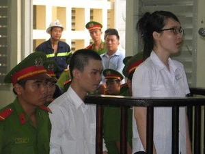 Hai bị cáo Đinh Nguyên Kha và Nguyễn Phương Uyên trước vành móng ngựa. (Ảnh: Thanh Bình/TTXVN)