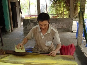 Người thợ miệt mài se hương (Ảnh: PV/Vietnam+)