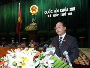 Phó Thủ tướng Nguyễn Xuân Phúc trình bày Báo cáo của Chính phủ trước Quốc hội. (Ảnh: Nhan Sáng/TTXVN)
