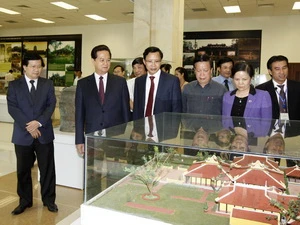 Thủ tướng xem mô hình trưng bày "Những ngôi nhà Việt" tại lễ công bố. (Ảnh: Đức Tám/TTXVN)