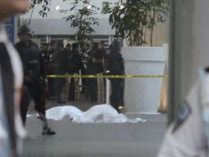 Các nhân viên an ninh đứng gần thi thể các cảnh sát liên bang bị sát hại tại sân bay quốc tế của thủ đô Mexico City. (Nguồn: AP)