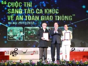 Phó Thủ tướng Nguyễn Xuân Phúc trao 2 giải Nhì cho các tác giả Lê Hàm (trái) và Nguyễn Lân Cường (phải). (Ảnh: Doãn Tấn/TTXVN)