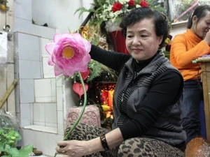 "Nữ hoàng hoa lụa" bên tác phẩm sen lụa nổi tiếng thương hiệu Mai Hạnh. (Ảnh: Thanh Hương/ Vietnam+)