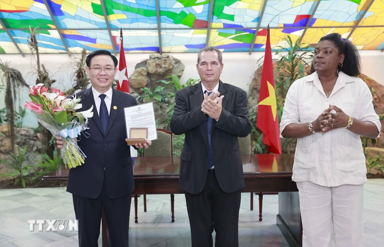 Lãnh đạo thành phố Santiago de Cuba trao kỷ niệm chương tặng Chủ tịch Quốc hội Vương Đình Huệ, vị khách danh dự của địa phương. (Ảnh: Doãn Tấn/TTXVN)