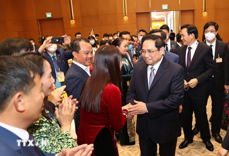 Thủ tướng Phạm Minh Chính gặp mặt kiều bào dự Xuân quê hương năm 2022. (Ảnh: Dương Giang/TTXVN)