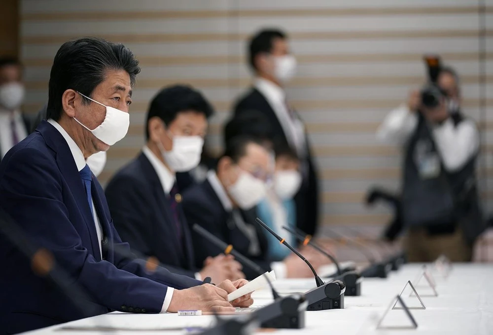 Thủ tướng Nhật Bản Shinzo Abe (trái) trong cuộc họp Chính phủ ngày 6/4/2020. (Ảnh: AFP/TTXVN)
