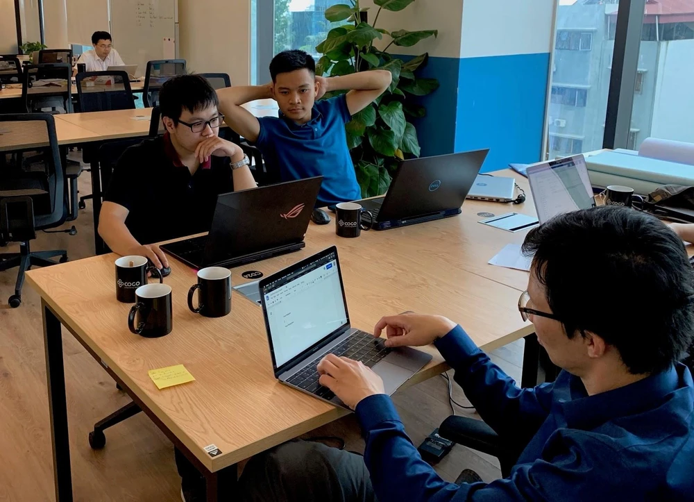 Nguyễn Đức Tùng (áo xanh, bên phải) học được cách tư duy của một nhà nghiên cứu khoa học cấp quốc tế tại VinAI. (Ảnh: Trần Dũng/Vietnam+)