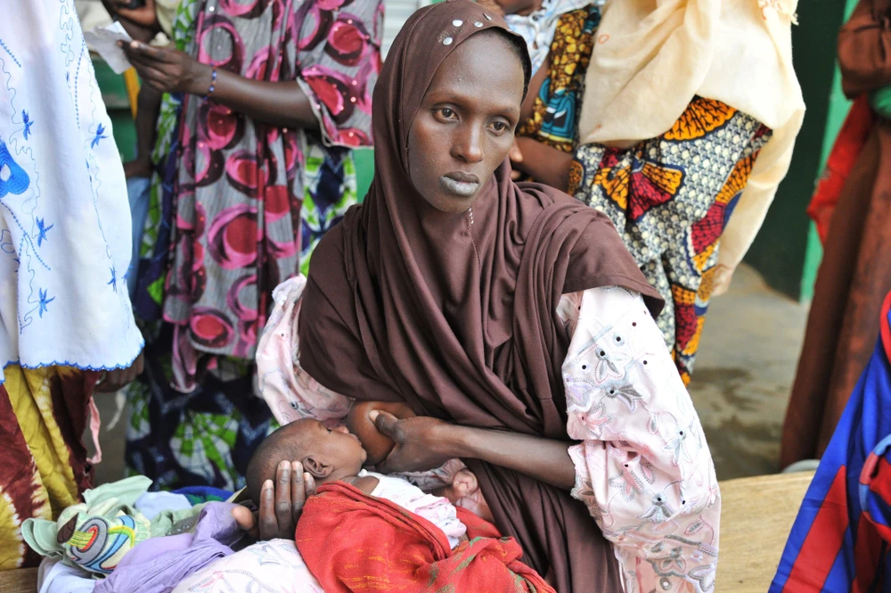 Một bà mẹ mang con bị suy dinh dưỡng tới khám tại bệnh viện ở Gao, Mali. (Ảnh: AFP/TTXVN)