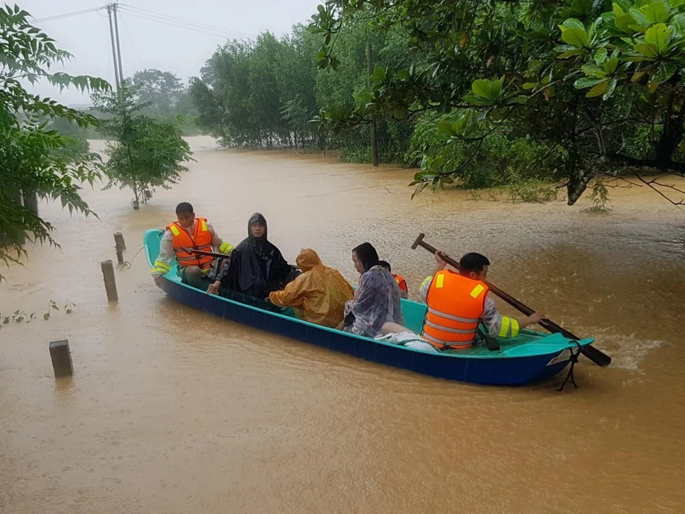Di chuyển người dân ra khỏi khu vực ngập lũ tại huyện Cam Lộ, tỉnh Quảng Trị. (Ảnh: Thanh Thủy/TTXVN)