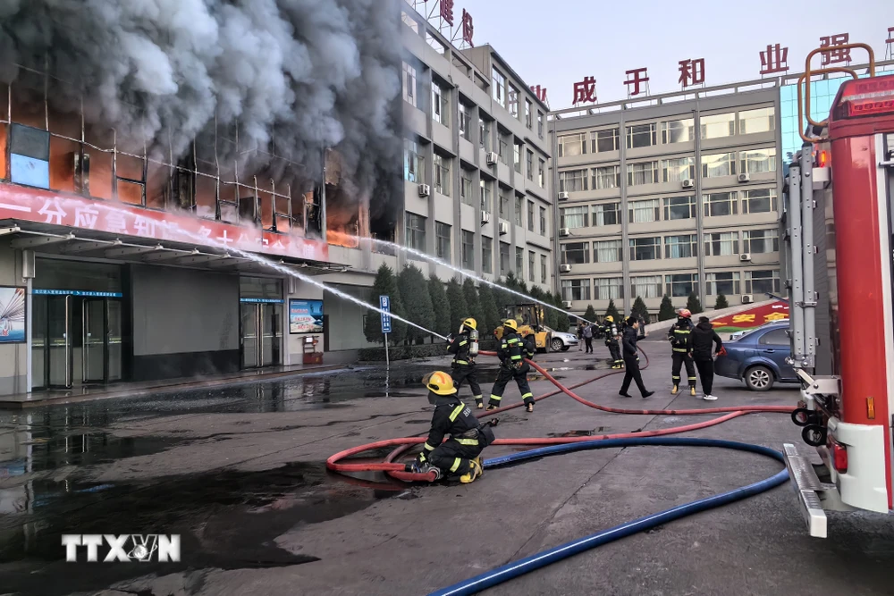 Lực lượng cứu hỏa nỗ lực dập lửa tại tòa nhà 5 tầng ở thành phố Lữ Lương, tỉnh Sơn Tây, miền Bắc Trung Quốc ngày 16/11/2023. (Ảnh: THX/TTXVN)