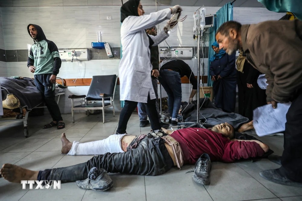 Điều trị cho người bị thương trong vụ tấn công của lực lượng Israel nhằm vào người dân Palestine chờ nhận hàng viện trợ nhân đạo tại thành phố Gaza, ở bệnh viện Kamal Edwan, ngày 29/2/2024. (Ảnh: AFP/TTXVN)