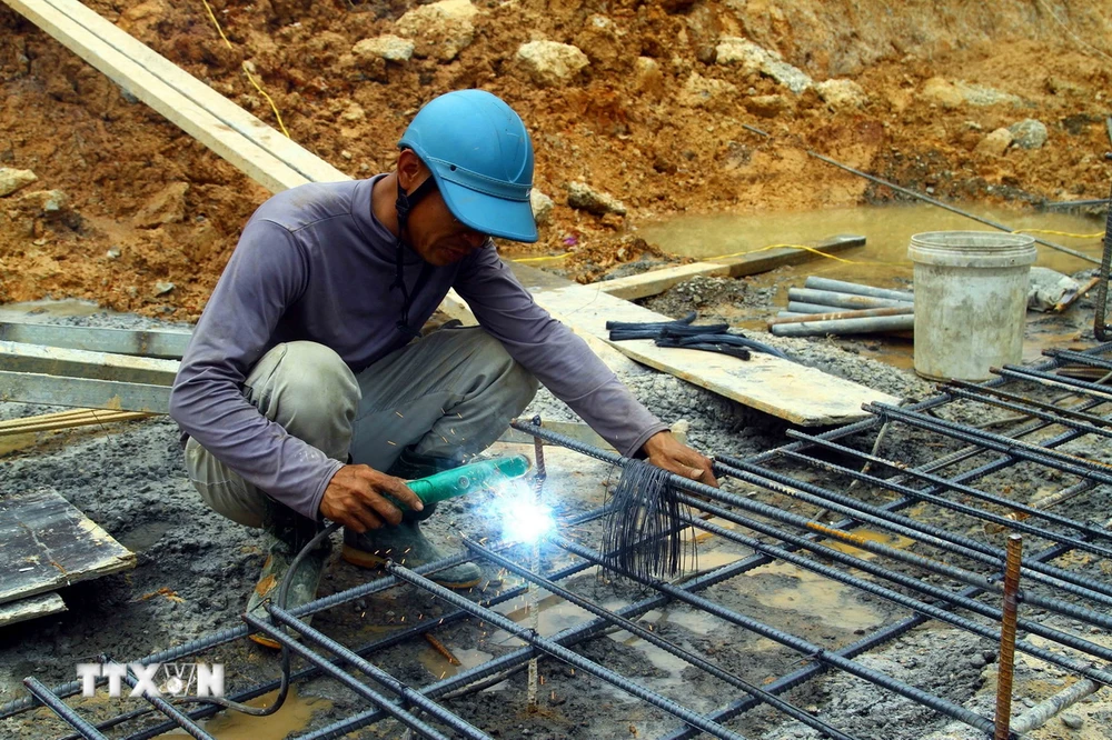 Công nhân làm xuyên Tết tại Dự án thành phần Vạn Ninh-Cam Lộ thuộc Dự án Cao tốc Bắc-Nam. (Ảnh: Tá Chuyên/TTXVN)