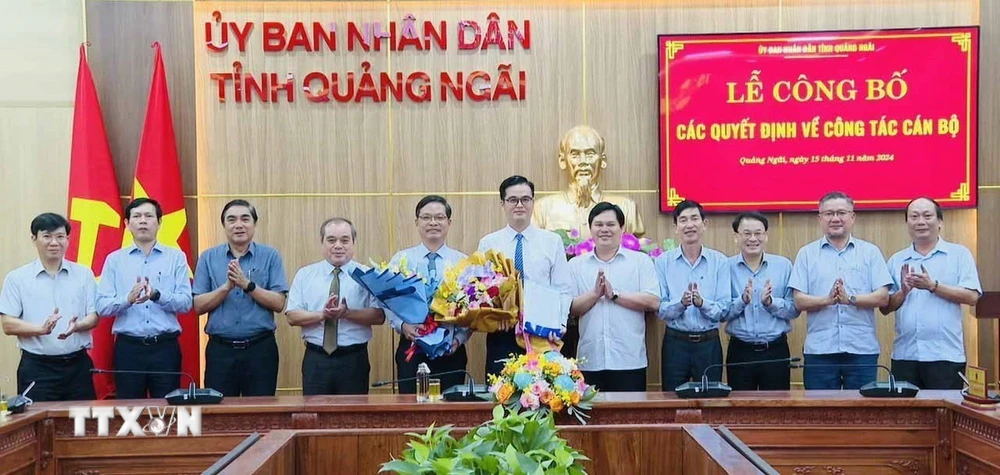 Lãnh đạo Ủy ban Nhân dân tỉnh Quảng Ngãi trao quyết định và tặng hoa chúc mừng Trưởng ban, Phó Trưởng Ban quản lý Khu kinh tế Dung Quất. (Ảnh: TTXVN)