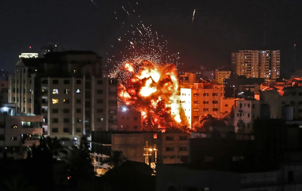 Một tòa nhà bị cháy trong vụ không kích của Israel vào Dải Gaza ngày 4/5. (Ảnh: AFP/TTXVN)
