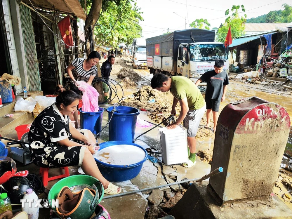 Các hộ dân xã Phúc Khánh, huyện Bảo Yên, Lào Cai đang tích cực dọn dẹp bùn đất, vệ sinh nhà cửa, sớm đưa cuộc sống quay lại bình thường. (Ảnh: Nam Sương/TTXVN)