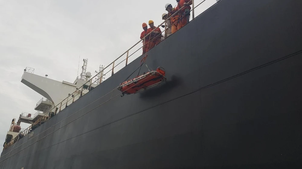 Tàu Great Aspiration đưa thuyền viên Wang Deqian xuống tàu SAR 413 để đưa thuyền viên bị nạn về bờ cấp cứu. (Nguồn: Trung tâm Phối hợp tìm kiếm cứu nạn Hàng hải khu vực 3)