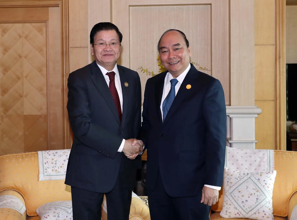 Thủ tướng Nguyễn Xuân Phúc gặp Thủ tướng Lào Thongloun Sisoulith tại Busan, Hàn Quốc. (Ảnh: Thống Nhất/TTXVN)