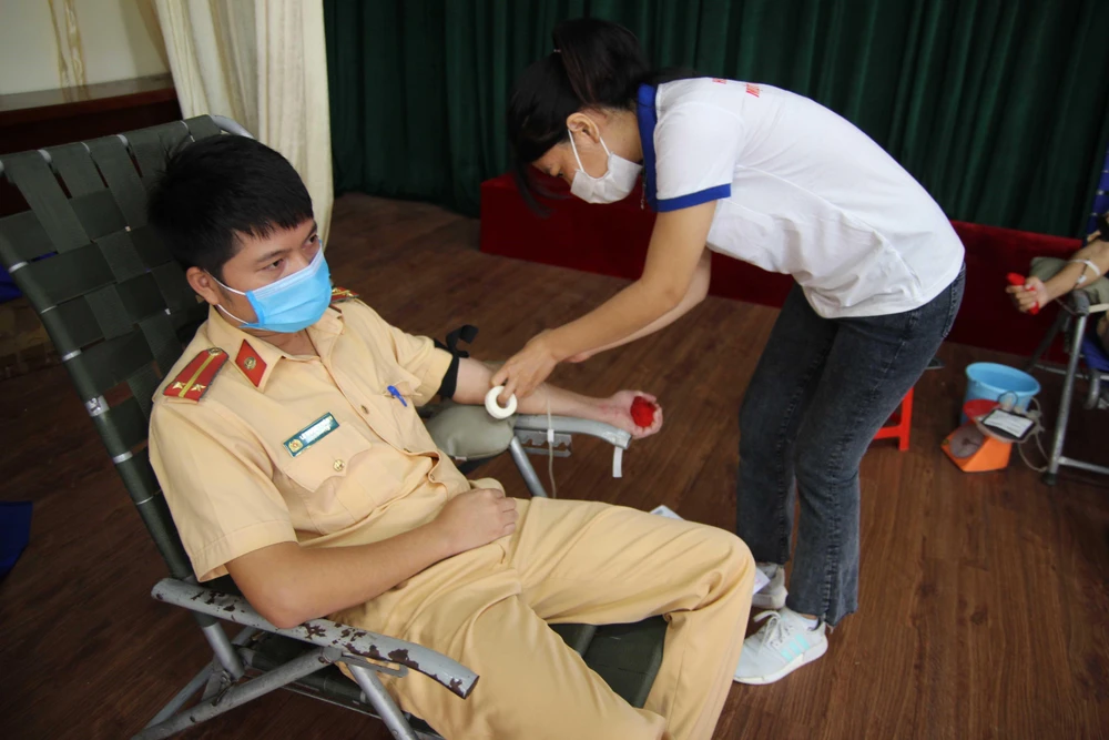 Các chiến sỹ công an tình nguyện hiến máu cứu người. (Ảnh: Ngọc Minh/TTXVN)