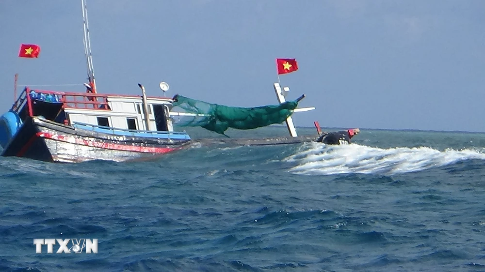 Tàu NT 02038TS bị mắc cạn và sóng đánh chìm. (Ảnh: TTXVN phát)