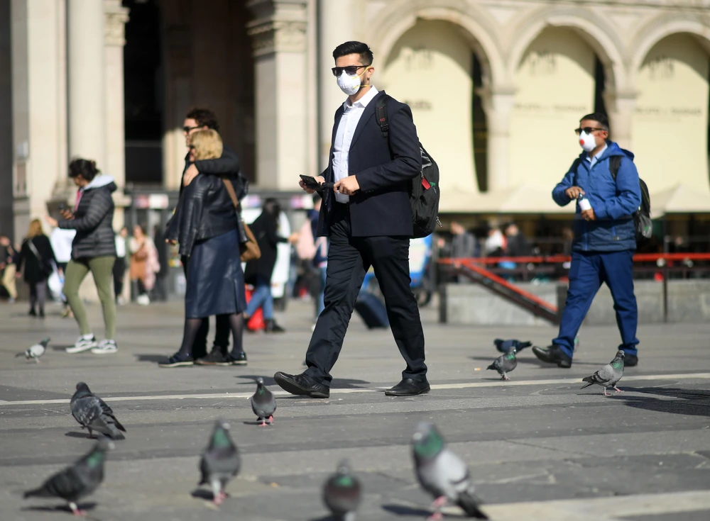 Người dân đeo khẩu trang phòng dịch viêm đường hô hấp cấp COVID-19 tại Milan, Italy. (Ảnh: THX/TTXVN)