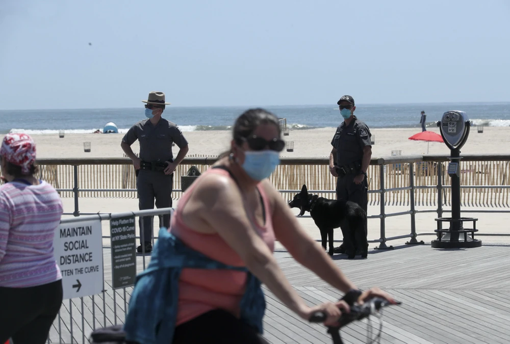 Cảnh sát gác trên bãi biển ở New York, Mỹ, ngày 22/5. (Ảnh: THX/TTXVN)