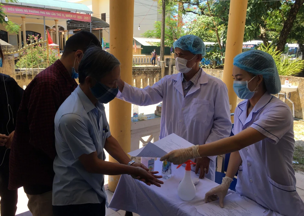 Tiến hành kiểm tra thân nhiệt, khai báo y tế tại chốt kiểm tra thị xã Hương Thủy, tỉnh Thừa Thiên-Huế. (Ảnh: Đỗ Trưởng-TTXVN)
