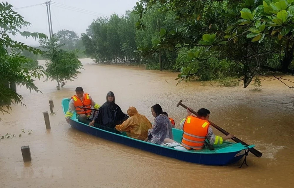 Di chuyển người dân ra khỏi khu vực ngập lũ tại huyện Cam Lộ, tỉnh Quảng Trị. (Ảnh: Thanh Thủy/TTXVN)