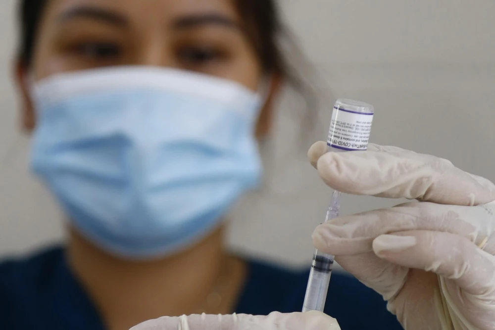 Nhân viên y tế chuẩn bị tiêm vaccine cho người dân. (Ảnh: Nam Sương/TTXVN)