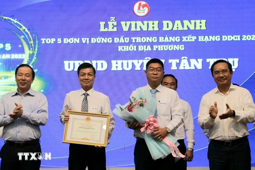 Bí thư Tỉnh ủy, Chủ tịch HĐND tỉnh Nguyễn Văn Được và Chủ tịch UBND Long An Nguyễn Văn Út tặng bằng khen đơn vị đứng đầu trong Bảng xếp hạng Chỉ số năng lực cạnh tranh khối sở, ban, ngành (DDCI) năm 2023. (Ảnh: Thanh Bình/TTXVN)