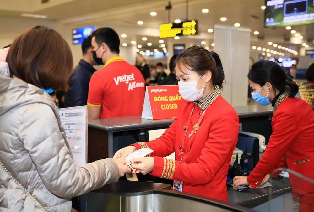 Hành khách làm thủ tục lên chuyến bay của hãng hàng không Vietjet. (Ảnh: CTV/Vietnam+)
