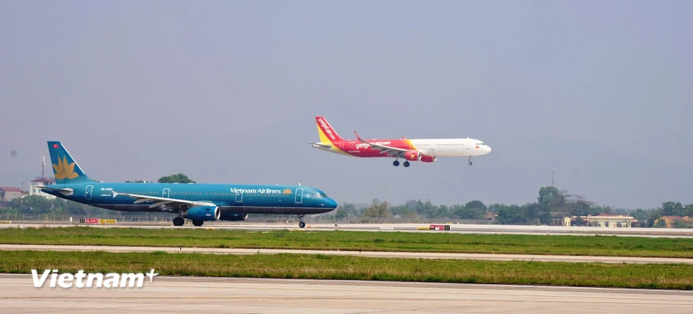 Máy bay của hãng hàng không Vietnam Airlines và Vietjet cất, hạ cánh tại một sân bay nội địa. (Ảnh: PV/Vietnam+)