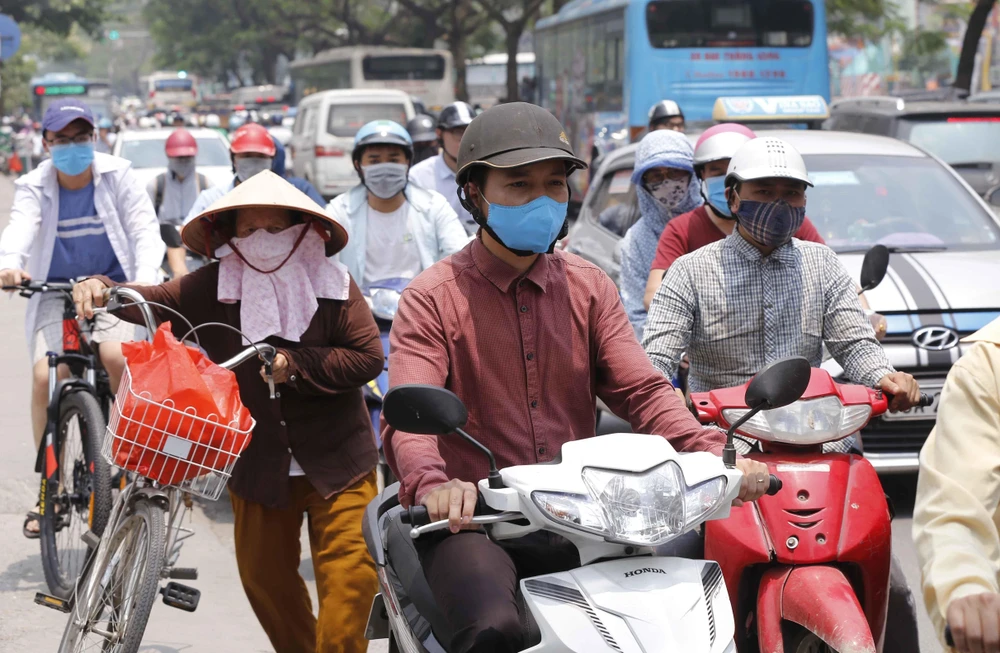 Người dân Hà Nội tham gia giao thông trên tuyến đường Minh Khai - Tam Trinh trong nắng nóng gần 40 độ C. (Ảnh: Doãn Tấn/TTXVN)