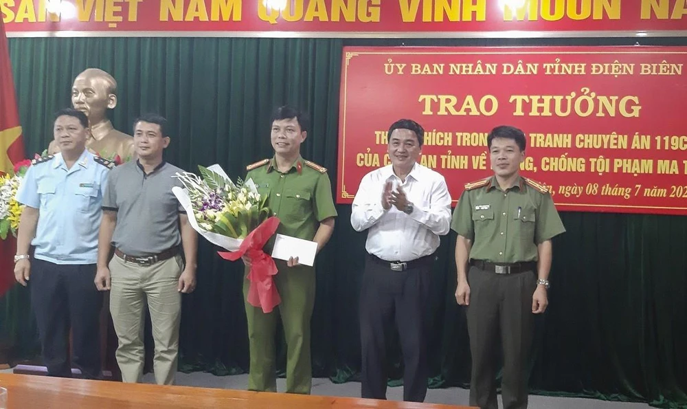 Phó Chủ tịch UBND tỉnh Điện Biên Lê Văn Qúy (thứ 2, từ phải qua trái) khen thưởng cho các thành viên của Ban chuyên án. (Ảnh: TTXVN)