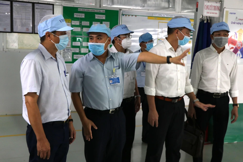 Đoàn công tác của Bộ Y tế làm việc tại Công ty TNHH Điện tử Foster Đà Nẵng (Khu công nghiệp Hòa Cầm). (Ảnh: Quốc Dũng/TTXVN)