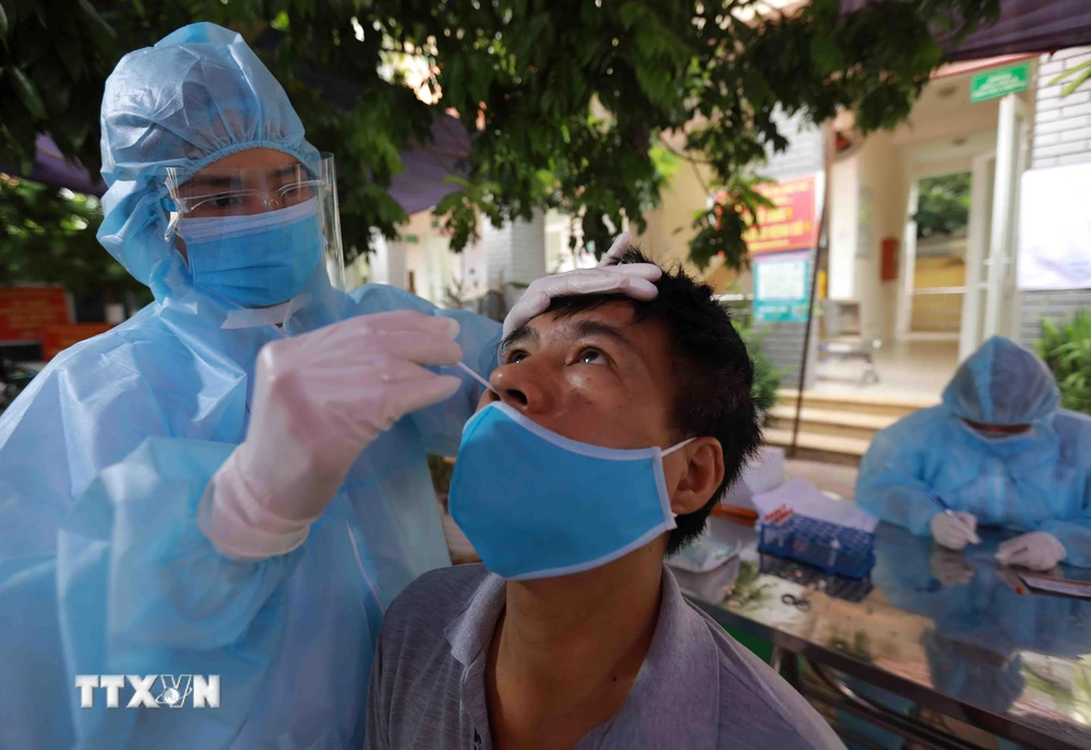 Nhân viên y tế lấy mẫu xét nghiệm cho người dân phường Tây Mỗ, quận Nam Từ Liêm, Hà Nội. (Ảnh: Vũ Sinh/TTXVN)