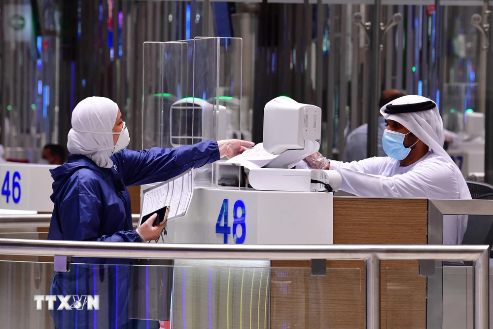 Hành khách làm thủ tục tại sân bay ở Dubai, Các Tiểu vương quốc Arab thống nhất (UAE). (Ảnh: AFP/TTXVN)