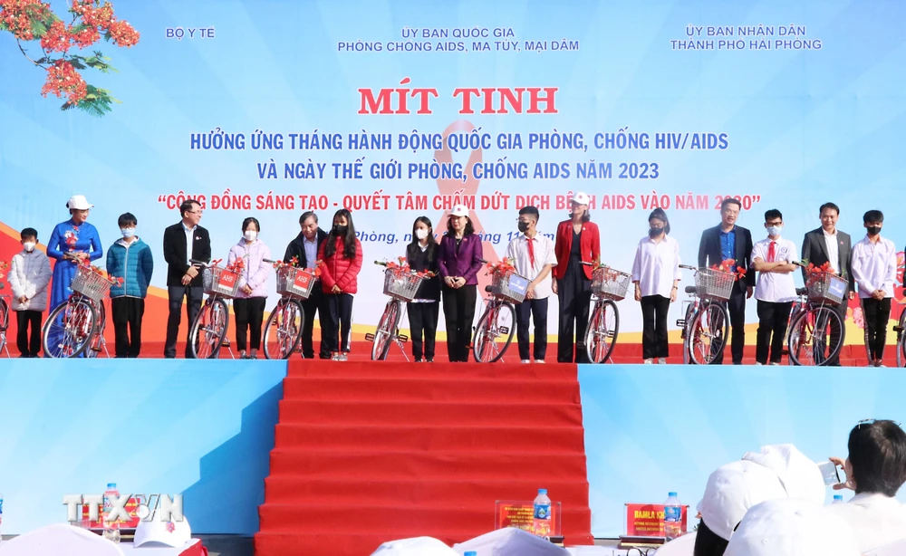 Bà Đào Hồng Lan, Bộ trưởng Bộ Y tế trao quà cho các cá nhân bị nhiễm HIV/AIDS tại lễ míttinh. (Ảnh: Hoàng Ngọc/TTXVN) 