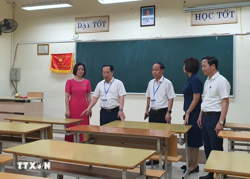 Kiểm tra phòng thi tại Trường THPT Thăng Long (quận Hai Bà Trưng). (Ảnh: Nguyễn Cúc/TTXVN)