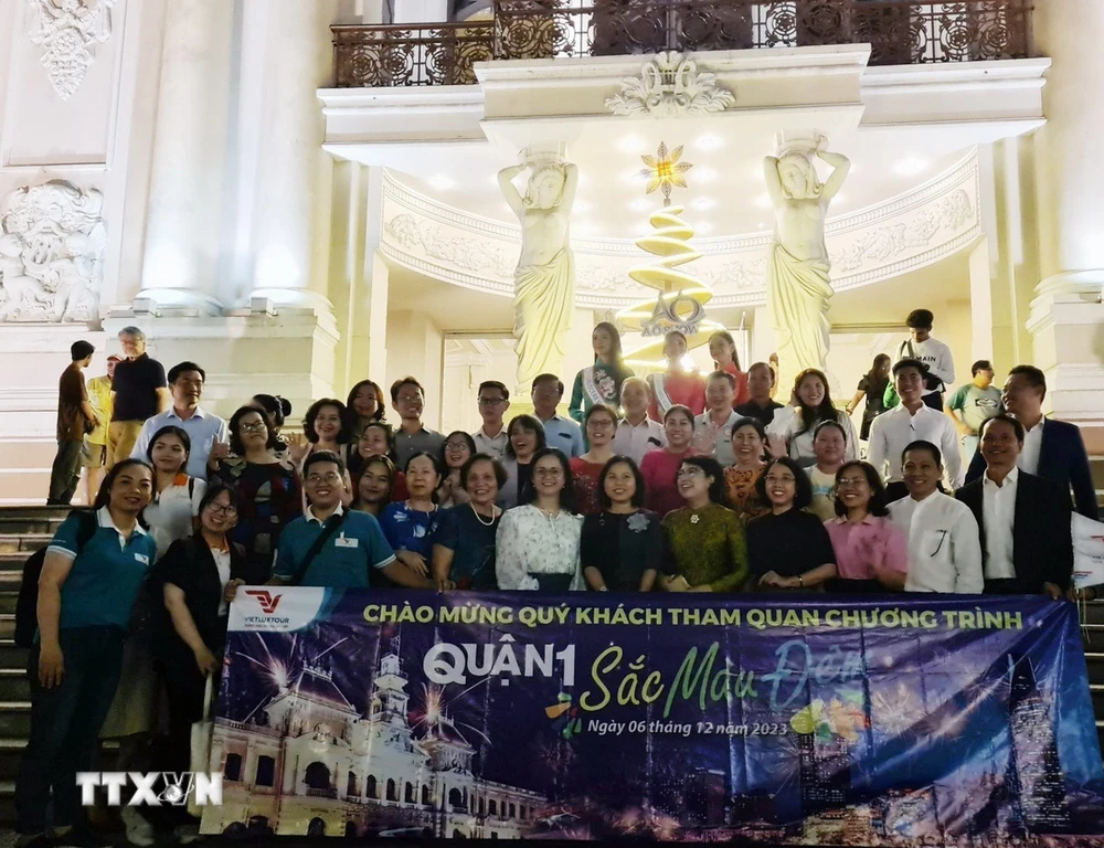 Đoàn du khách trải nghiệm tour “Quận 1 - Sắc màu đêm” tại Thành phố Hồ Chí Minh. (Ảnh: Mỹ Phương/TTXVN)