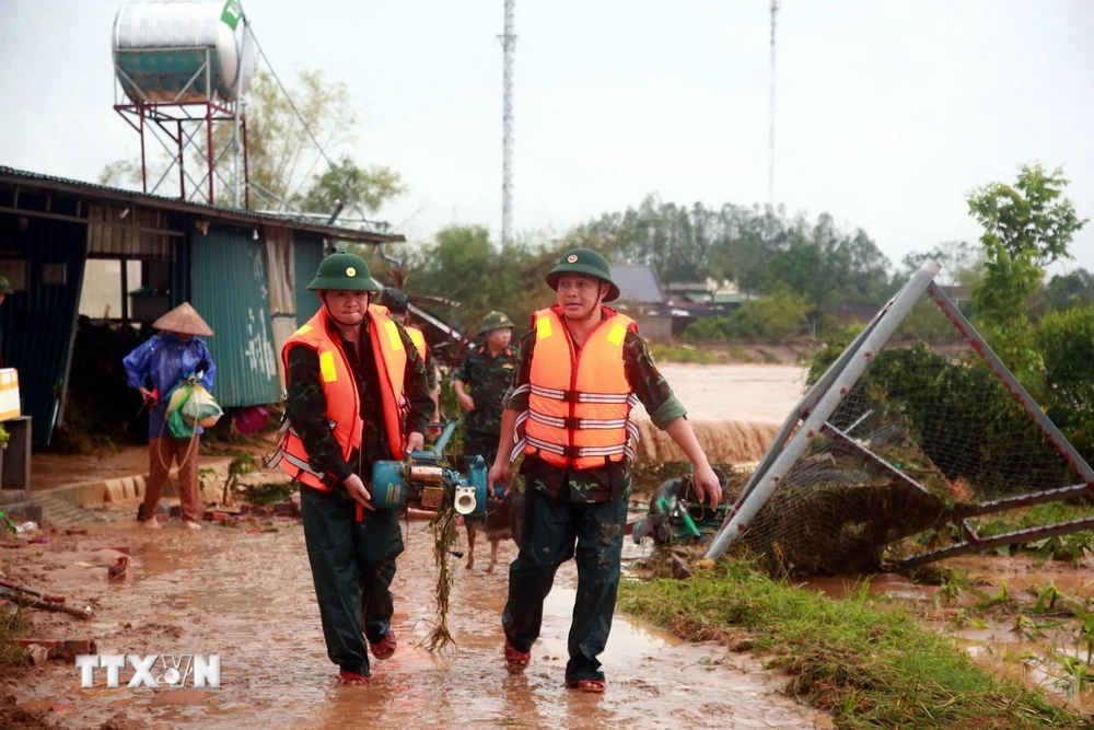 Lực lượng bộ đội giúp người dân ở xã Đông Hải, huyện Tiên Yên vận chuyển đồ đạc về nơi an toàn sau sự cố đập Hà Thanh. (Ảnh: TTXVN phát)