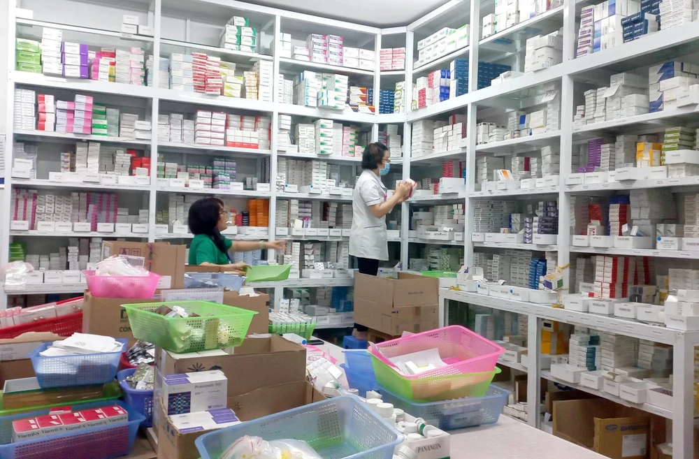 Nhân viên y tế làm công tác cấp phát thuốc. (Ảnh: T.G/Vietnam+)