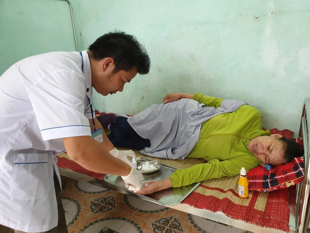 Nhân viên y tế tại Trạm y tế xã Quảng Phương (Quảng Trạch, Quảng Bình) khám chữa bệnh cho người dân. (Ảnh: T.G/Vietnam+)