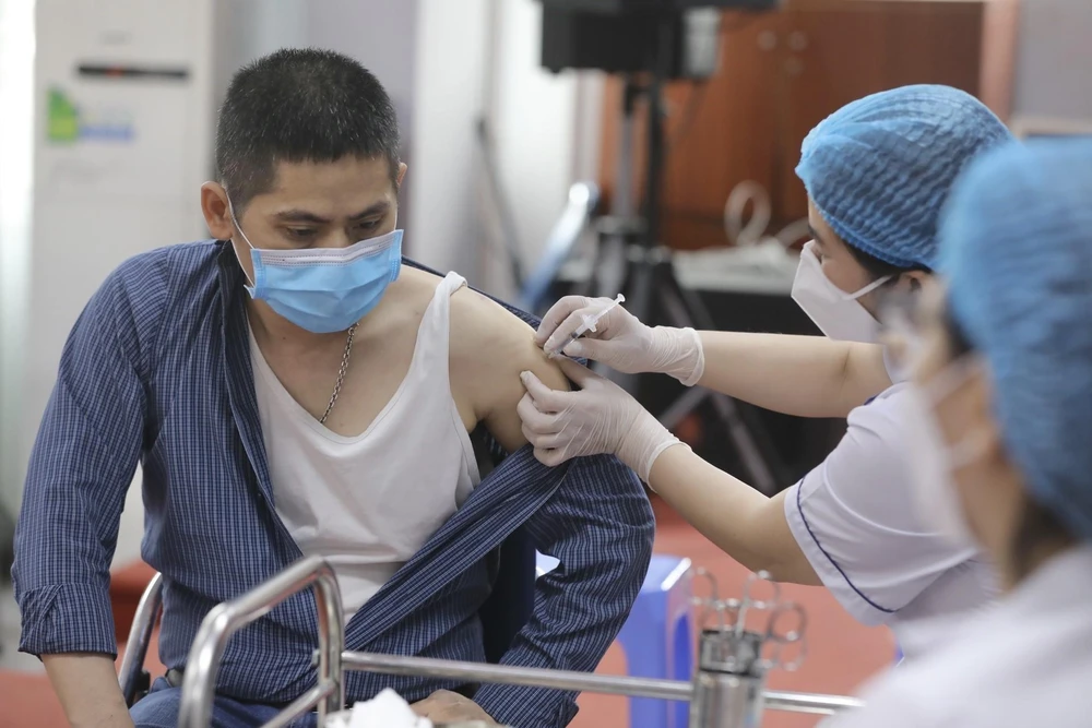 Nhân viên y tế quận Hai Bà Trưng tiêm vaccine phòng COVID-19 cho người dân. (Ảnh: Minh Quyết/TTXVN)