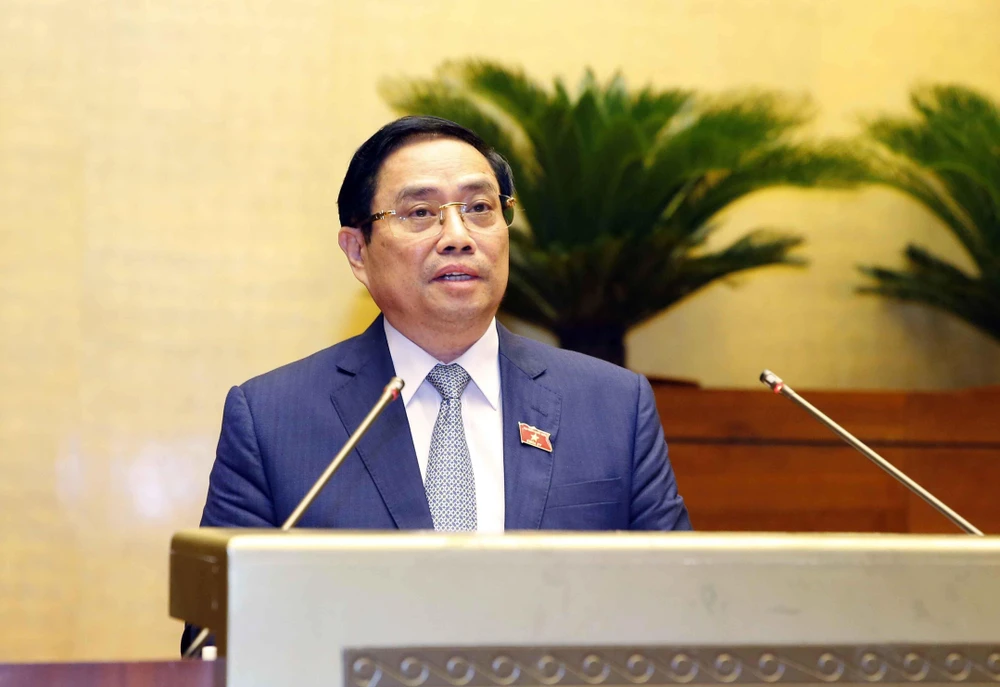 Thủ tướng Phạm Minh Chính trình Quốc hội về cơ cấu tổ chức của Chính phủ nhiệm kỳ 2021-2026. Ảnh: Doãn Tấn/TTXVN)