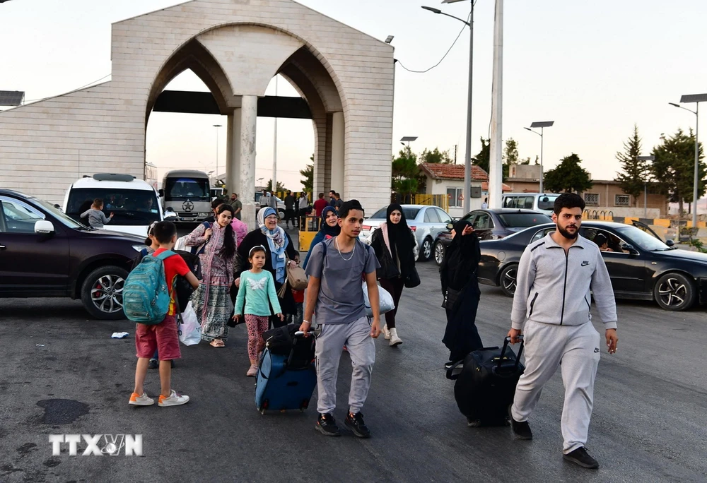 Người dân sơ tán khỏi Liban di chuyển qua cửa khẩu biên giới Jdeidat Yabous với Syria. (Ảnh: THX/TTXVN)