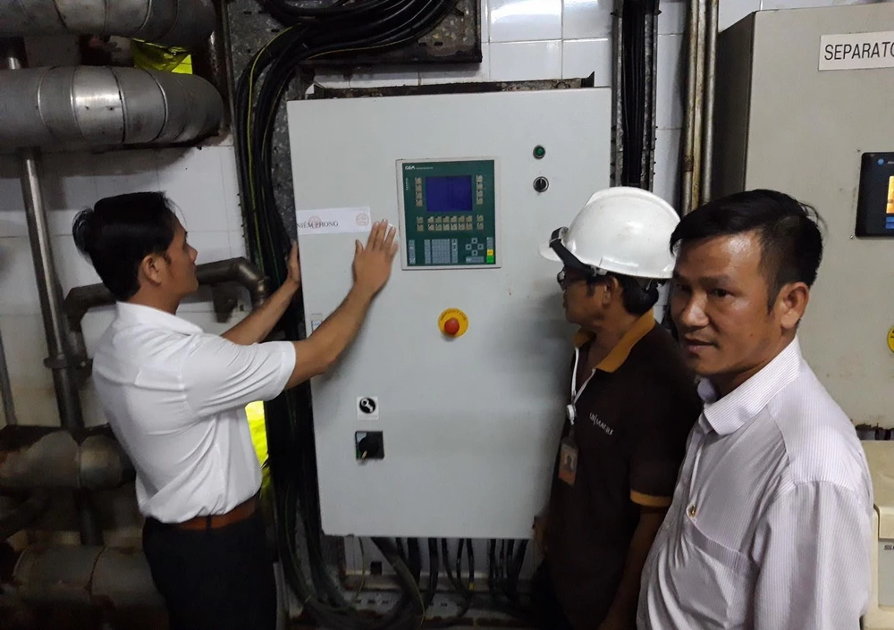 Ngành chức năng tiến hành niêm phong dây chuyền sản xuất của Công ty AB Mauri Việt Nam. (Ảnh: Công Phong/TTXVN)
