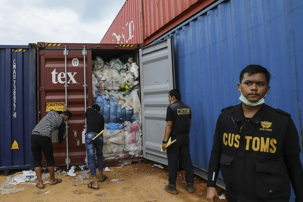 Nhân viên Hải quan Indonesia kiểm tra container chứa rác thải nhựa tại cảng Batu Ampar ở Batam, ngày 15/6 vừa qua. (Ảnh: AFP/TTXVN)