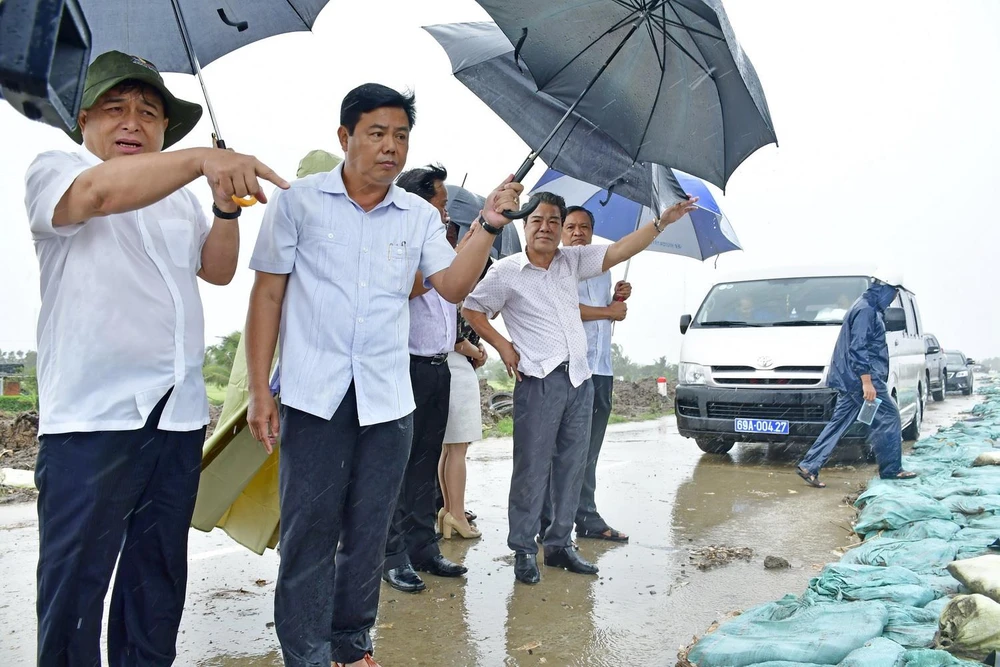 Bộ trưởng Bộ Kế hoạch và Đầu tư Nguyễn Chí Dũng (bên trái) kiểm tra tình hình sạt lở bờ biển Tây, tỉnh Cà Mau. (Ảnh: Thế Anh/TTXVN)